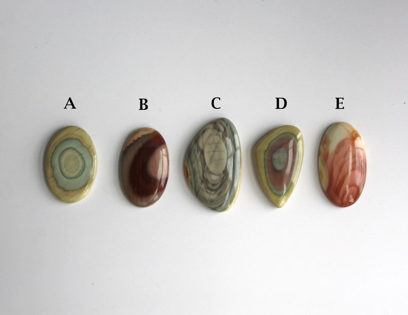May include: Five oval-shaped polished stones with different patterns and colors, labeled A through E.