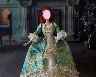 May include: A doll in a teal and gold brocade gown with white lace trim and pearl accents. The doll has red hair and is wearing gold earrings. The gown features a layered skirt and ornate detailing, evoking a historical theme.