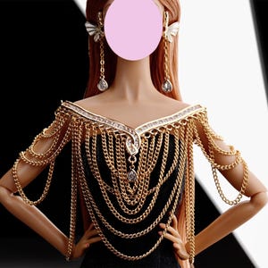May include: A gold chain necklace with a large, ornate pendant and clear crystal accents. The necklace is worn as a shoulder piece and has a V-shaped neckline.