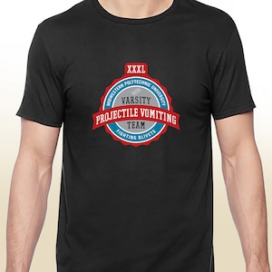 May include: Black t-shirt with a red, white, and blue circular logo that says "Midwestern Polytechnic University Varsity Projectile Vomiting Team Fighting Blivets" and "XXXL" at the top.