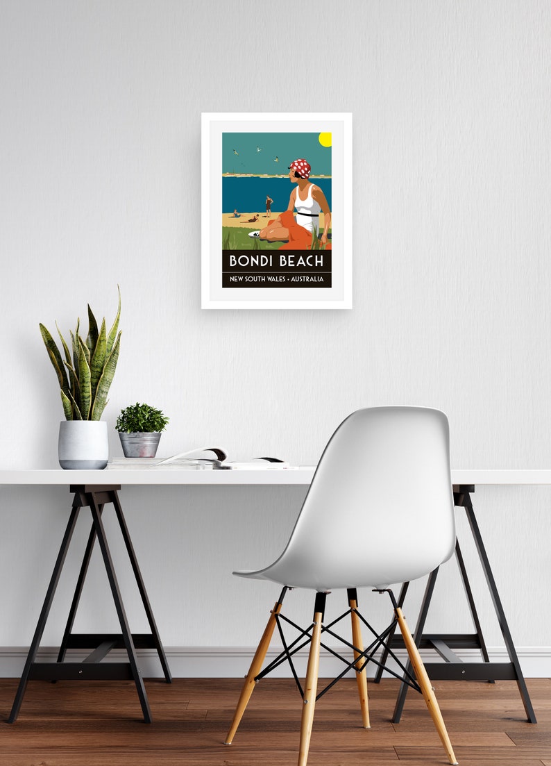 May include: A framed poster with a retro illustration of a woman sitting on a beach in a white swimsuit and red and white polka dot hat. The poster says "Bondi Beach, New South Wales, Australia".
