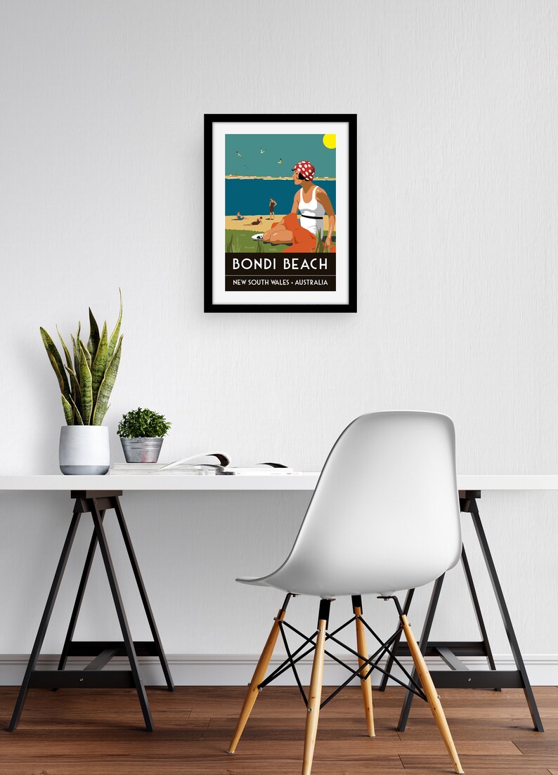 May include: A framed illustration of a woman sitting on a beach with a red and white polka dot hat, a white tank top, and orange shorts. The illustration is titled "Bondi Beach, New South Wales, Australia".