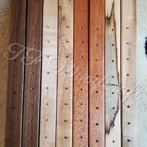 May include: A set of 10 wooden dowels with holes drilled along their length. The dowels are in various shades of brown, beige, and reddish-brown.
