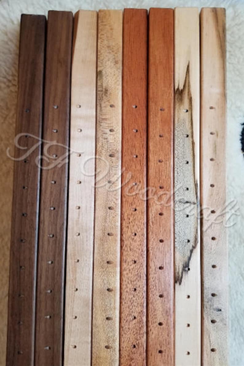 May include: A set of 10 wooden dowels with holes drilled along their length. The dowels are in various shades of brown, beige, and reddish-brown.