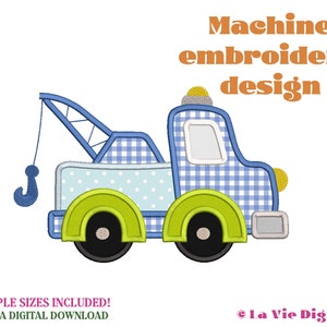 May include: Machine embroidery design of a blue and white checkered tow truck with a green tow hook and wheels. The truck has a white and blue checkered pattern and a yellow light on top.