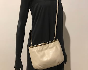 A vintage vinyl shoulder bag with unique opening mechanism