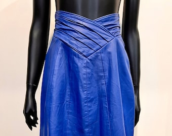 A bright electric blue leather panelled skirt with unique pleated yoke detail
