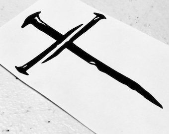 May include: A black and white image of a simple cross with a rough, hand-drawn style.