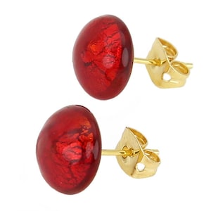 May include: A pair of red oval-shaped stud earrings with gold-colored posts and butterfly backs. The earrings have a glossy, reflective finish, and the red color has a textured appearance. The earrings are set against a white background.