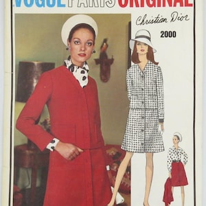 May include: A vintage Vogue Paris Original fashion magazine cover featuring a woman in a red suit and a fashion illustration of a woman in a black and white dress. The text "Vogue Paris Original" and "Christian Dior 2000" are displayed.