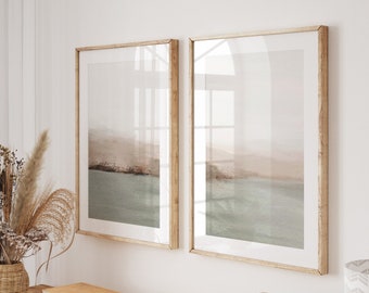 May include: A wooden console table with a light wood finish. The table has two shelves and is decorated with a vase of dried flowers, books, and a decorative bowl. Two framed prints of a seascape hang on the wall behind the table.