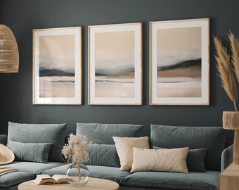 May include: A living room with a sectional sofa in a dark blue color, three framed abstract landscape paintings in muted tones of brown, beige, and gray, a woven pendant light, and a woven coffee table.