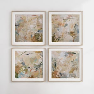 May include: Four abstract paintings in beige, brown, and blue tones are displayed in a grid on a white wall. Each painting is framed in a light wood frame.