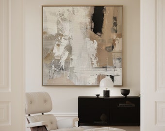 May include: A white leather armchair and ottoman with a wooden base and chrome legs. The chair and ottoman are in front of a black cabinet with a white lamp and a brown bowl on top. A large abstract painting with brown, white, and black colors hangs on the wall behind the cabinet.