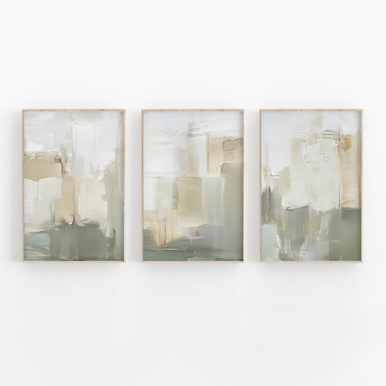 May include: Three framed abstract art prints. Each print features a textured, layered design in shades of white, beige, and green. The artwork has a modern, minimalist aesthetic, suitable for home decor.