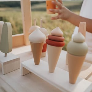 Wooden ice cream cones on a tray — natural wooden Montessori toy for imaginative play.