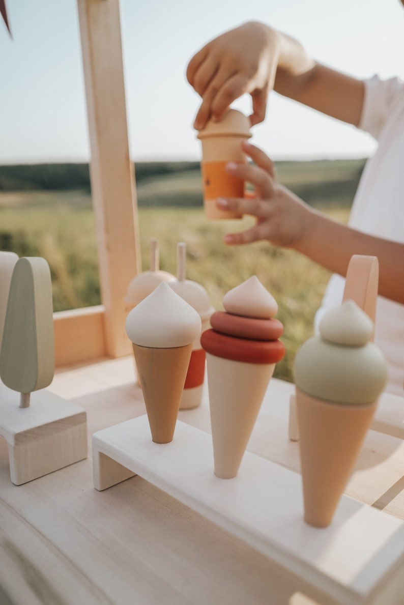 Wooden ice cream cones on a tray — natural wooden Montessori toy for imaginative play.