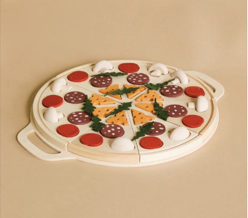 May include: A wooden pizza toy with various toppings, including red and brown pepperoni, cheese, and mushrooms. The pizza is divided into slices and is ready for play.