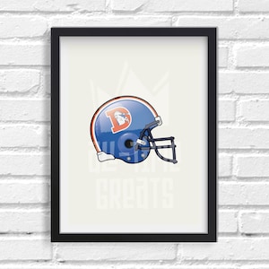 May include: A blue and orange football helmet with a white 'D' on the side. The helmet is in a black frame against a white brick wall.