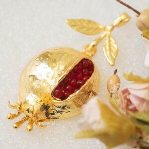 Pendant with auspicious pomegranate, brass and ruby quartz