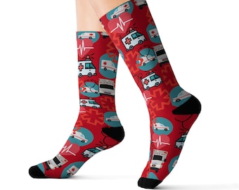 May include: Red socks with a pattern of white ambulances, red crosses, and blue stethoscopes. The socks are on a white background.