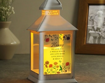 May include: White lantern with a floral design and the text "Nanny We love you a whole bunch and lots more Love Jessica & Emily X"