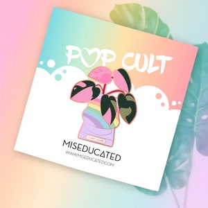 May include: A pink and green plant with rainbow stripes in a pot with the text "Plant Lover" on it. The text "Pop Cult" and "Misedcuated" are also on the image.