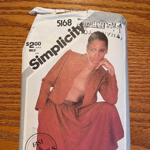 May include: Vintage Simplicity sewing pattern, number 5168, featuring a woman in a rust-colored skirt suit. The pattern package includes the text "Fast & Fabulous" and "Top not included."