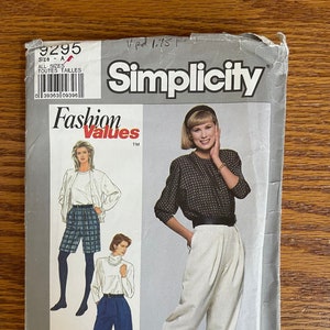 May include: A vintage Simplicity sewing pattern, size A, featuring illustrations of women's fashion. The pattern includes designs for a jacket, shorts, and pants. The cover has the text "Fashion Values" and the Simplicity logo.