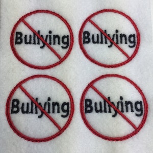 May include: Four embroidered patches with a red circle and a red diagonal line, with the word "Bullying" in black. The patches are on a white fabric background.