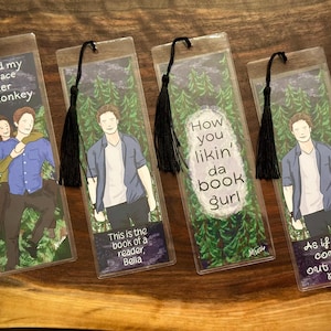 May include: Four rectangular clear bookmarks with black tassels, each featuring forest illustrations and character art. Text includes: Hold my place Spider Monkey, This is the book of a reader Bella, How you likin' da book gurl, and As if you could out read me.