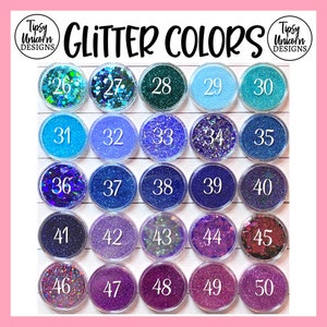 May include: A collection of 50 small jars filled with different colors of glitter. The jars are arranged in a grid of five rows and five columns. Each jar is labeled with a number from 26 to 50.