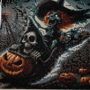 May include: A diamond painting kit featuring a Halloween-themed design. The image includes a skull, a jack-o'-lantern, and a witch. The dimensions are 197.8 x 30 cm. The kit includes a color list and the number 568.