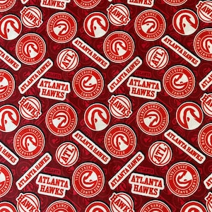 May include: Red and white fabric with a repeating pattern of the Atlanta Hawks logo. The logo features a red hawk with white wings and a basketball. The text "Atlanta Hawks" is written in white on a red banner.