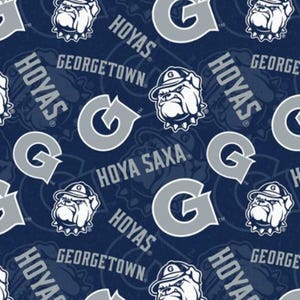May include: Navy blue fabric featuring a repeating pattern of the letter "G", bulldog mascot, and the words "HOYAS" and "GEORGETOWN" in white and gray. The design is a collegiate theme.