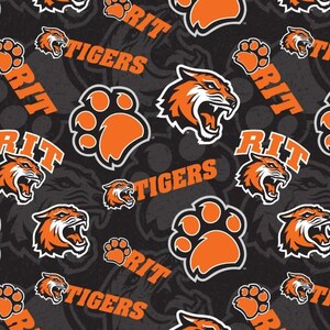 May include: A repeating pattern on a black background featuring orange tiger paw prints, tiger heads, and the text "RIT" and "TIGERS" in orange. The design is suitable for fabric or wallpaper.