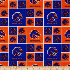 May include: A blue and orange fabric with a repeating pattern of a horse head logo and the text "BOISE STATE TM".