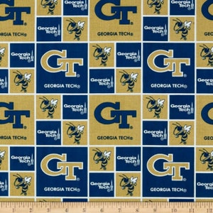 May include: A blue and gold fabric with a repeating pattern of the Georgia Tech logo and a yellow bumblebee. The logo says "Georgia Tech" and features the letters "GT" in a gold circle.