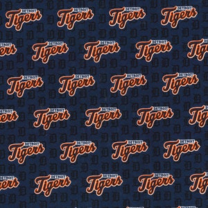 May include: A blue fabric with a repeating pattern of the words "Detroit Tigers" in orange and black lettering.