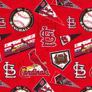May include: Red fabric with a repeating pattern of St. Louis Cardinals baseball team logos, including a baseball, a cardinal bird, a bat, and the team's 'STL' logo. The fabric has a distressed, vintage look.