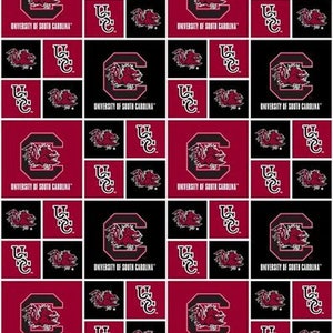May include: A red and black fabric with a repeating pattern of the University of South Carolina logo. The logo features a garnet-colored 'C' with a gamecock inside. The text 'University of South Carolina' is written below the logo.