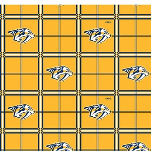 May include: A yellow and blue plaid fabric with a repeated pattern of a blue and white hockey team logo. The logo is a stylized predator with a white outline and a white letter "N" on its chest. The text "©NHL" appears in the upper right corner of the fabric.