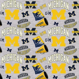 NCAA UNIVERSITY of MICHIGAN WOLVERINEs Cheer Print Football 100% cotton fabric material you choose length licensed Quilts