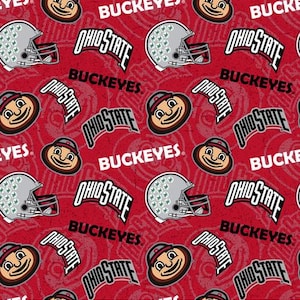 May include: Red fabric with a repeating pattern of the Ohio State Buckeyes logo, a football helmet, and a cartoon mascot. The text "Ohio State" and "Buckeyes" is repeated throughout the pattern.