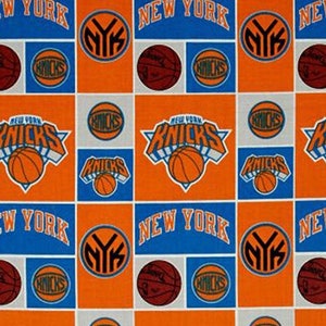 May include: Orange and blue fabric with a repeating pattern of the New York Knicks logo, basketballs, and the words "New York".