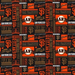 May include: A black and orange fabric with a repeating pattern of the San Francisco Giants logo, the team's name, and the year 1958. The pattern also includes baseball bats, baseballs, and the Golden Gate Bridge.