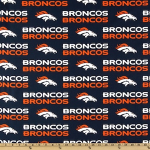 May include: Navy blue fabric featuring a repeating pattern of the word "BRONCOS" in white and orange, along with a white and orange horse head logo. The fabric is suitable for various crafting projects.