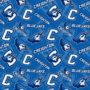 May include: A blue and white repeating pattern featuring the Creighton Bluejays logo. The logo includes a blue jay, the letter C, and the words "Creighton" and "Bluejays".