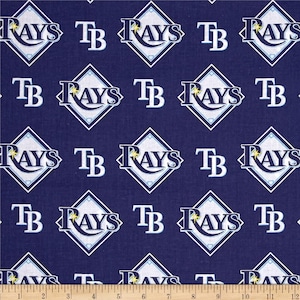 May include: A navy blue fabric with a repeating pattern of white and blue diamond-shaped logos. The logos say "Rays" and "TB" in white lettering.