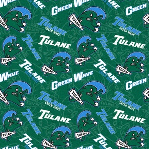 May include: A green and blue patterned fabric with the words "Tulane Green Wave" repeated throughout. The pattern also includes a cartoon wave with a face and a megaphone.